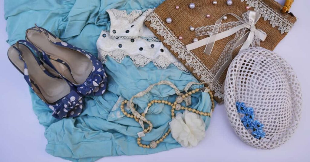 A blue summer outfit for a woman laid out on a white background.