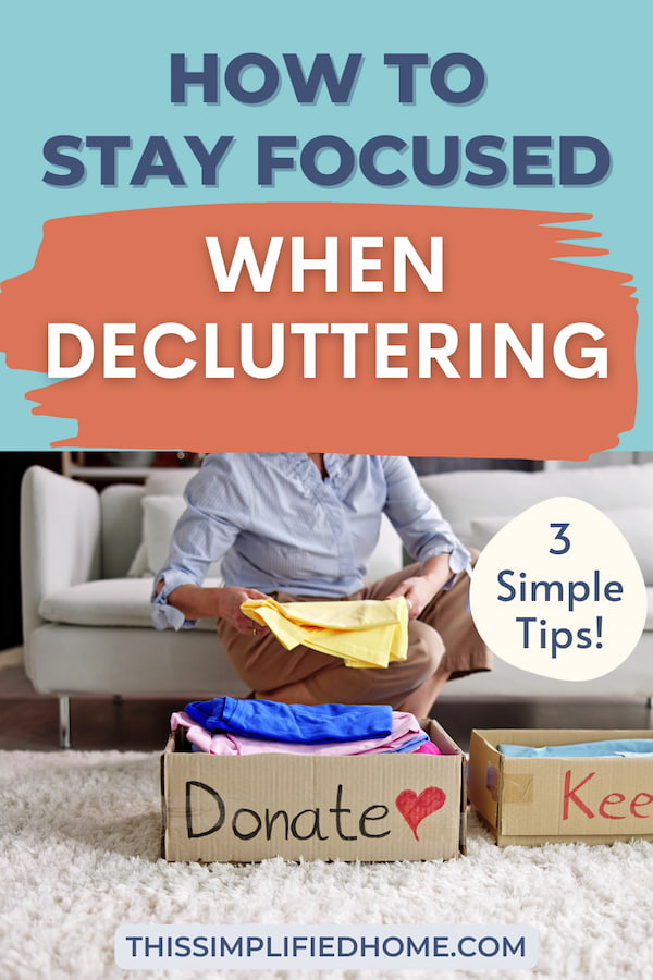 Woman kneeling behind two boxes while decluttering. One is labeled"Donate," the other is labeled,"keep".