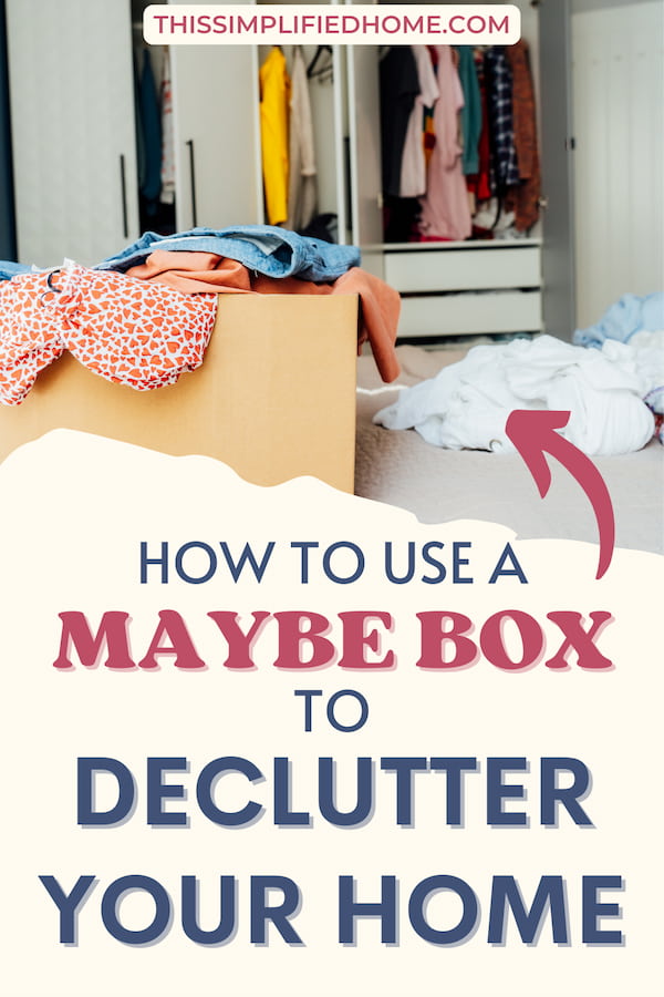 An open closet with a Maybe Box sitting in front of it with clothes inside to determine if they can be decluttered later.